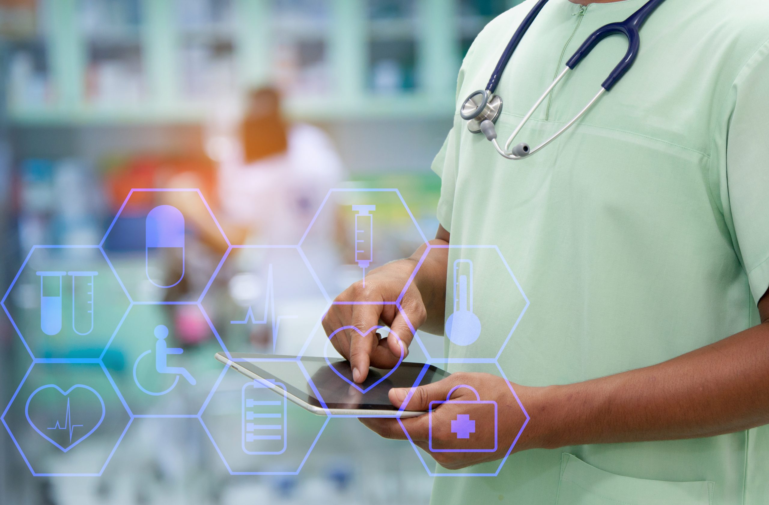A healthcare professional in scrubs uses a tablet, with medical icons like pills, heart, and syringe digitally overlaid. Pharmacy shelves and another worker are visible in the blurred background.
